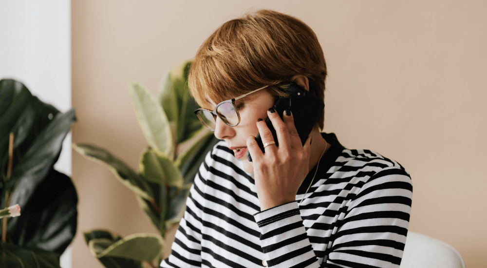 Woman at home talking on her mobile phone